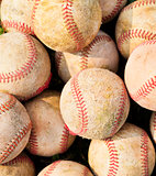 closeup of pile up a stack of old baseball in green