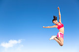 happy young woman jumping in the sky