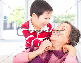  a boy playing with grandmother at home