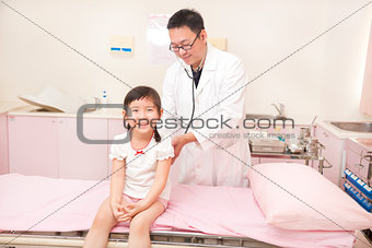 male pediatrician examining little girl in the clinic