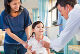 pediatrician examining little girl , her mother beside her