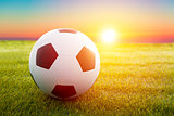 soccer ball on the field with sunset 