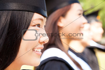 close-up smiling female university graduate  with classmates