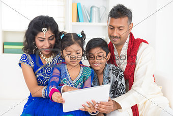 Indian family using tablet pc computer at home