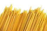 Uncooked Italian spaghetti on a white background.