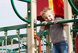 Boy on playground equipment.