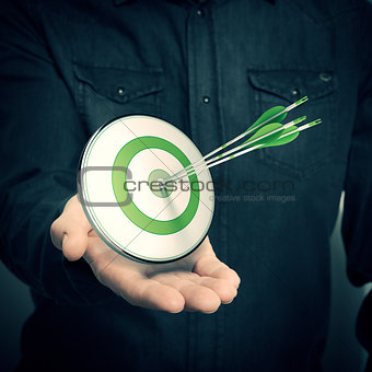 Man Holding Green Target - Marketing Solutions Concept