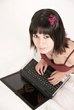Woman Works on Laptop Computer Sitting on Floor