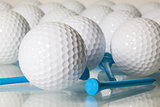 Many golf balls on a glass table