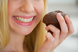 Closeup on young woman holding chocolate muffin