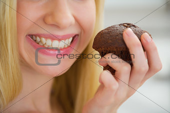 Closeup on young woman holding chocolate muffin