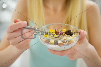 Closeup on young woman eating healthy breakfast