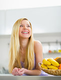 Portrait of smiling young woman in kitchen