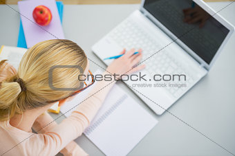 Young woman studying in kitchen
