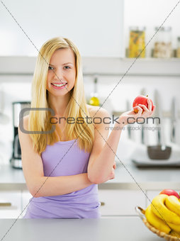 Portrait of happy young woman with apple