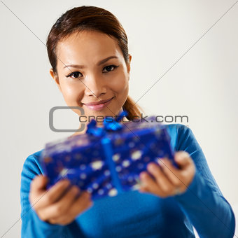 asian girl holding gift box to the camera