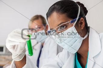 Female Asian Scientist with Test Tube In Laboratory