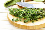 Fresh fragrant green thyme on a cutting board