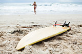 Surfboard in sand on beach