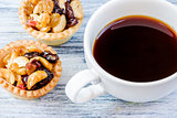 Black coffee and Fruit Tart  on wooden table