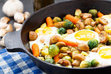 Baked eggs with vegetables and mushrooms