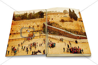 An opened old book with a picture Western Wall,Temple Mount, Jerusalem.Photo in old color image style.
