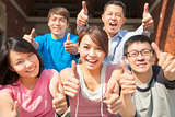 Group of happy students with thumbs up