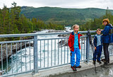 Family near mountain river waterfalls (Norge)
