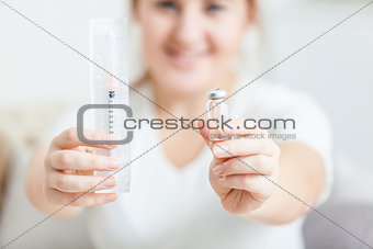 Photo of young woman holding syringe