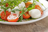 salad from arugula tomatos and baby mozzarella