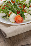 salad from arugula tomatos and baby mozzarella