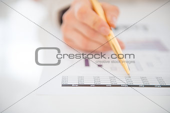 Closeup on business woman checking document