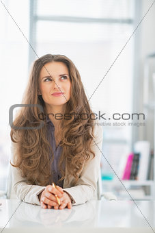 Thoughtful business woman looking on copy space