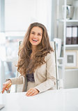Portrait of happy business woman sitting in office