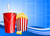 Popcorn and cup of soda on film background