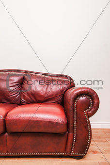 Luxurious Red Leather Couch in front of a blank wall