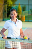 girl with a ball and a tennis racket at the net worth