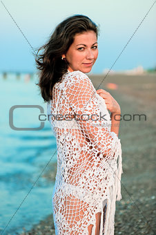young woman in white pareo handmade sea