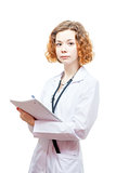 cute redhead doctor in lab coat with notebook