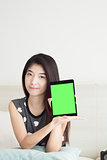 Young Asian woman show or display and pointing tablet