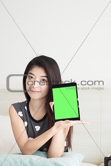 Young Asian woman show or display and pointing tablet