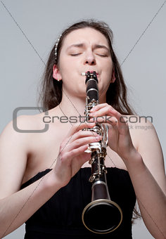 Young Female Musician Playing Clarinet
