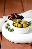 marinated green and black olives (Kalamata) in a ceramic bowl
