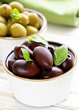 marinated green and black olives (Kalamata) in a ceramic bowl