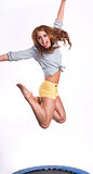 You Attractive Woman Does Jump Excercise onTrampoline in Shorts