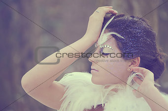 Beautiful girl fashion portrait with a feather bolero  Frozen bride make up  Eyes closed