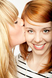 blond girl give red haired girl kiss