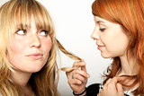 two beautiful girls looking at hair