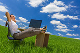 Woman Relaxing at Office Desk in Green Field