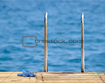 Steel and wooden ladder pier on the sea